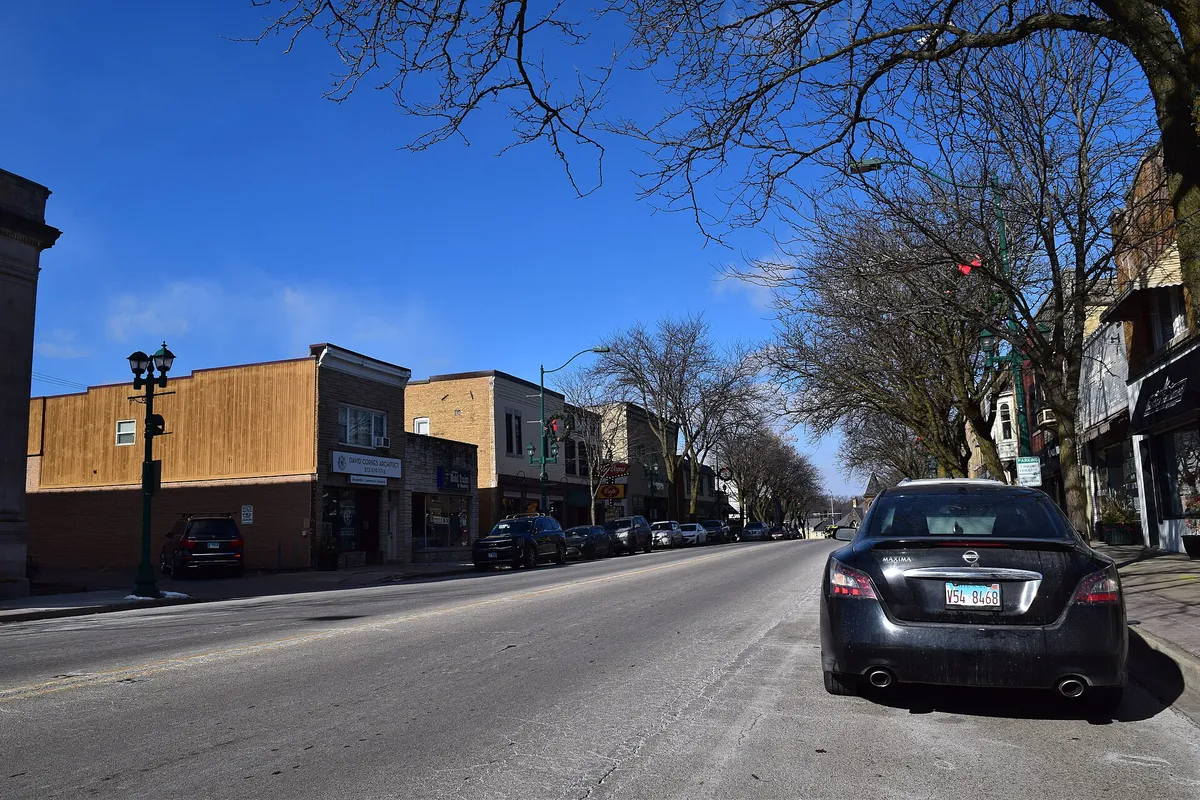 Brick storefronts and a tree-lined street in Antioch’s Route 83 business district