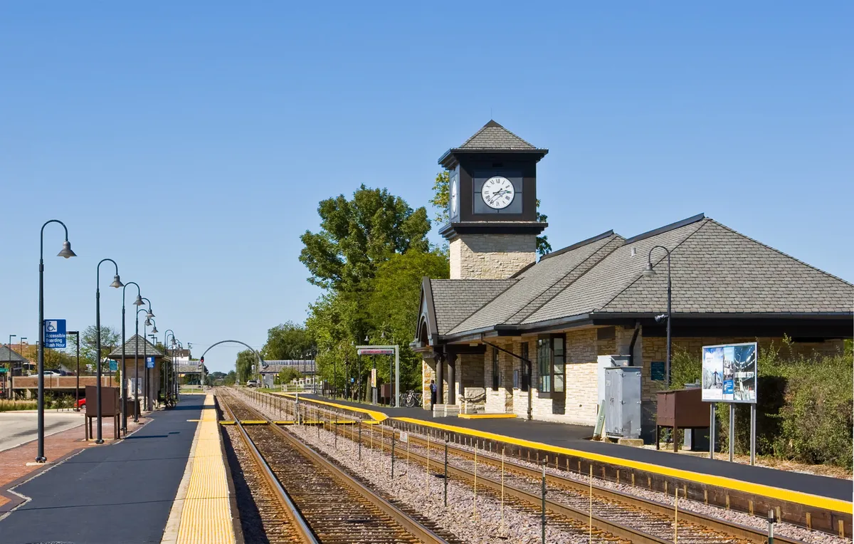 Highland Park station building with a clock tower beside the railway tracks